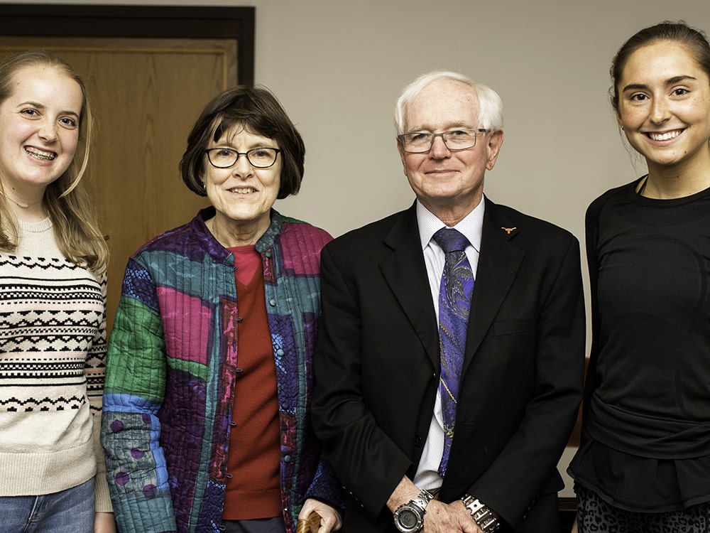 Linda Norris smiling with husband Lee Norris and Texas engineering students
