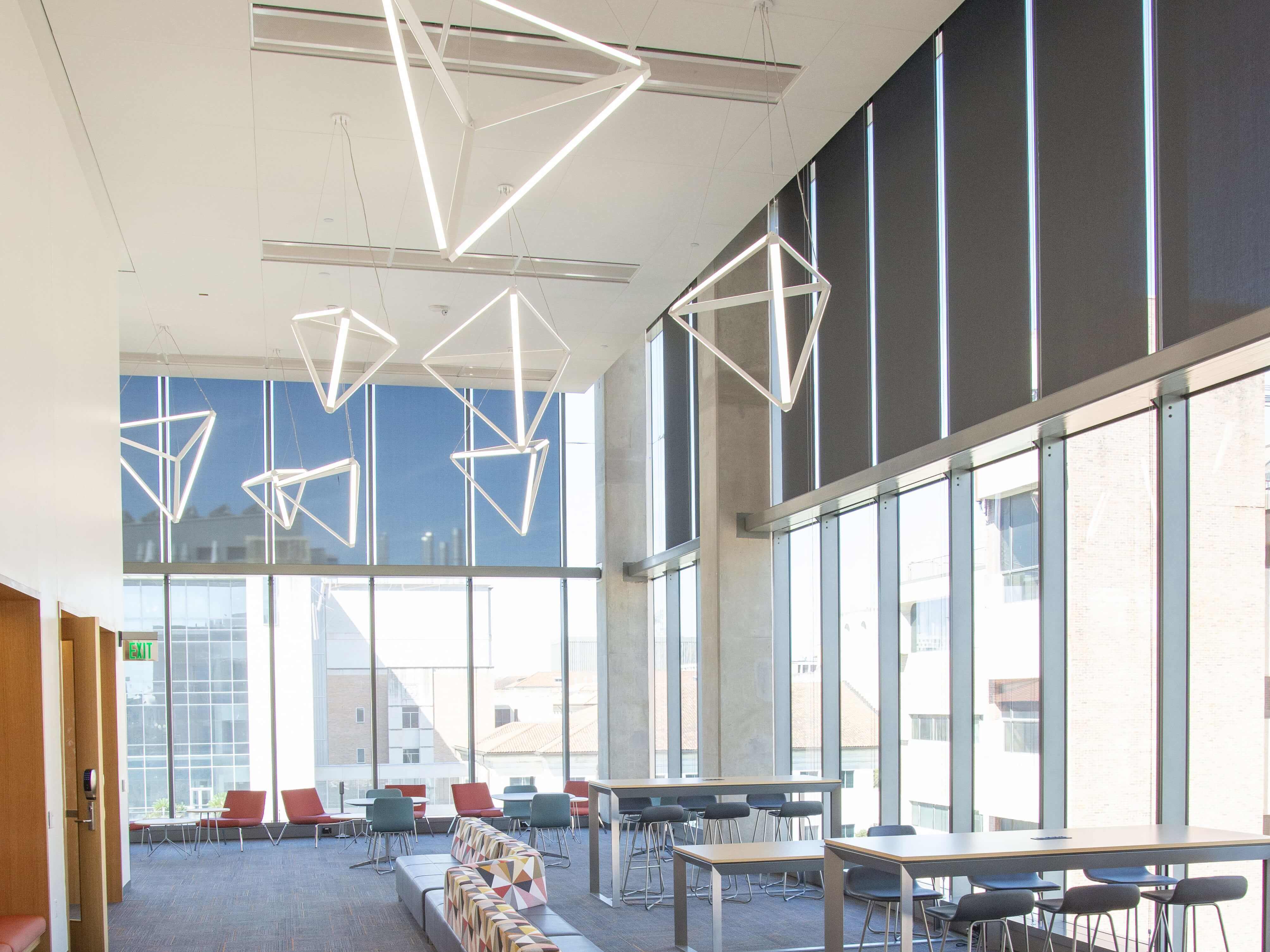 Interior of GLT building including work tables, cushioned benches and large windows