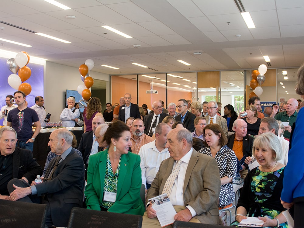 A crowd of people sitting at the Aerospace Engineering Building opening event