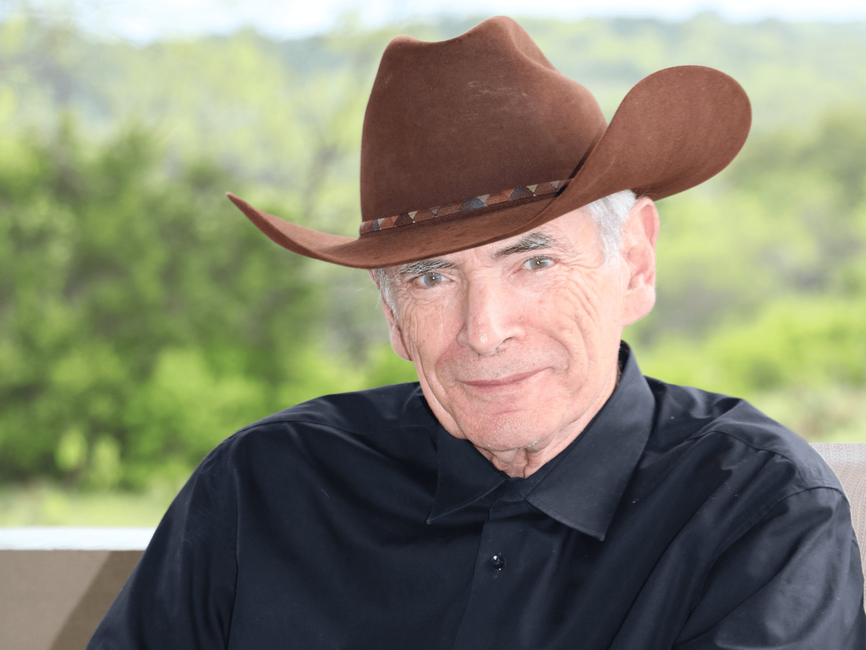 J. Tinsley Oden smiling while wearing a cowboy hat
