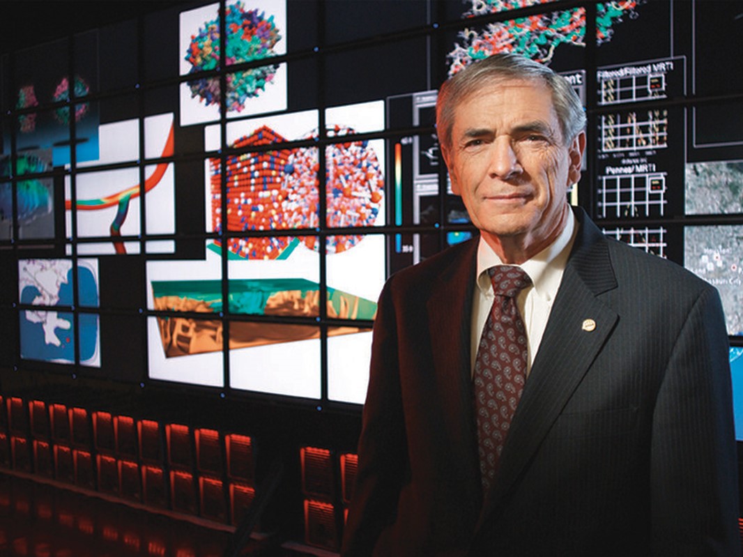 J. Tinsley Oden standing in front of virtual screens at the Oden Institute