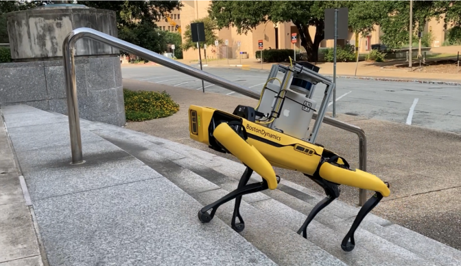 small robot walking up a flight of stairs