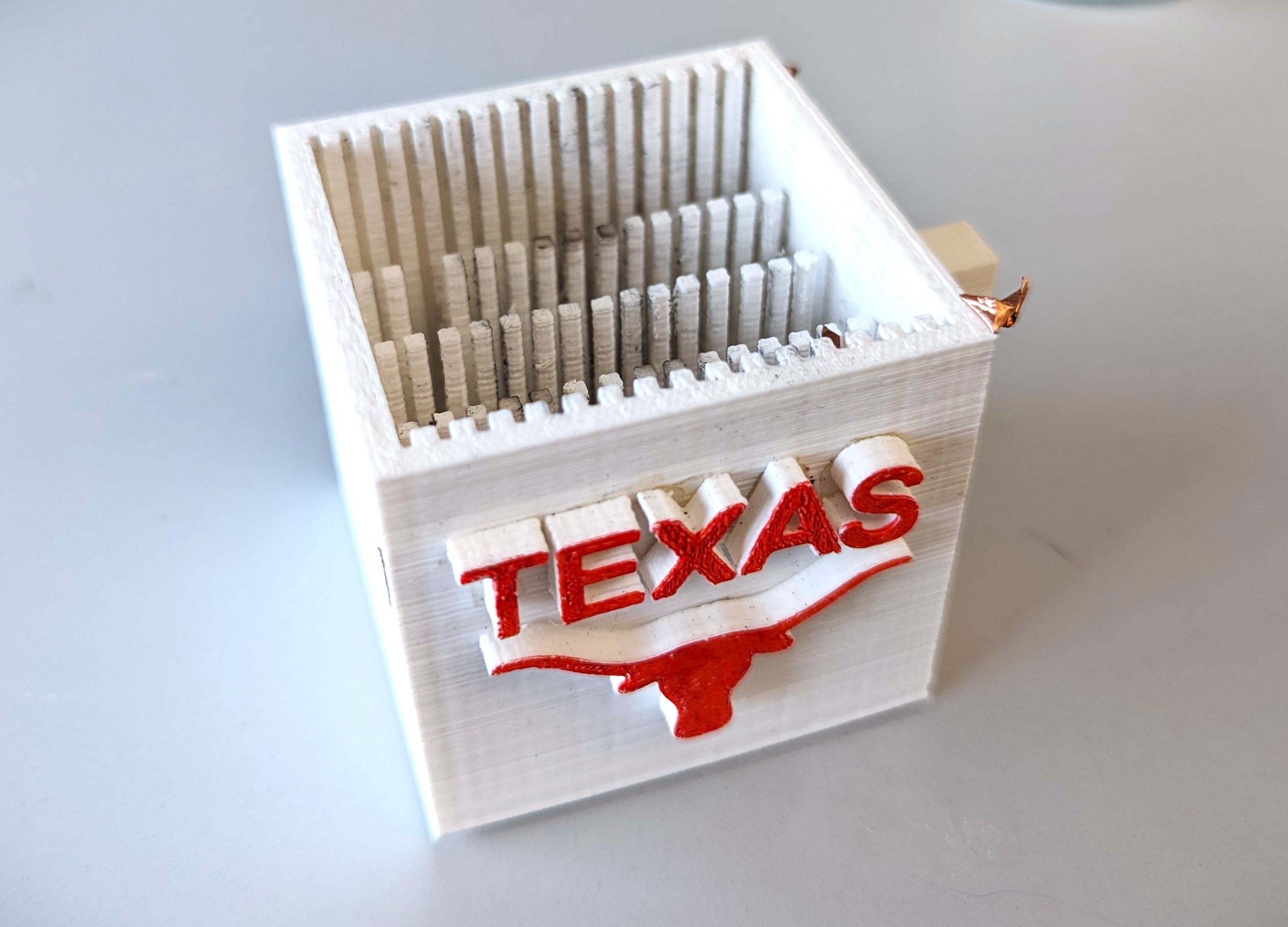 Emma Fan's water purifying cup design with UT Austin logo