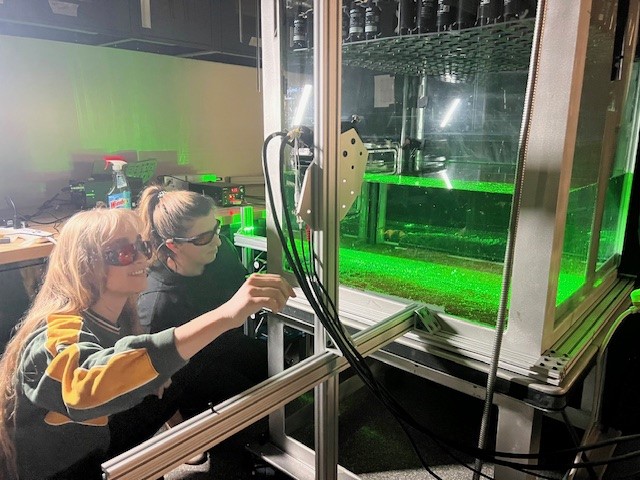 Professor Blair Johnson working on wave simulation device with Cockrell graduate student Alexandra Stephens