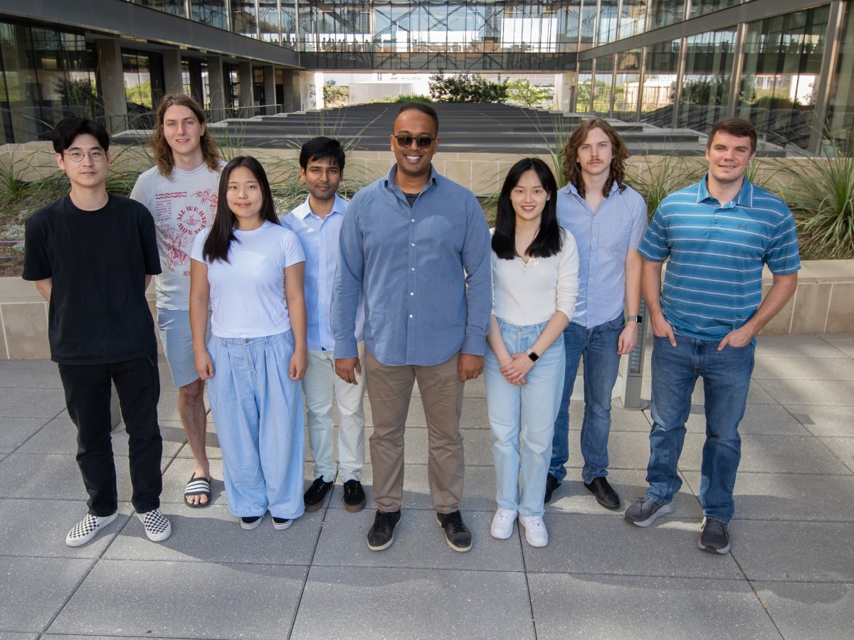 Texas Engineer Shwetadwip Chowdhury poses with students at The University of Texas at Austin..