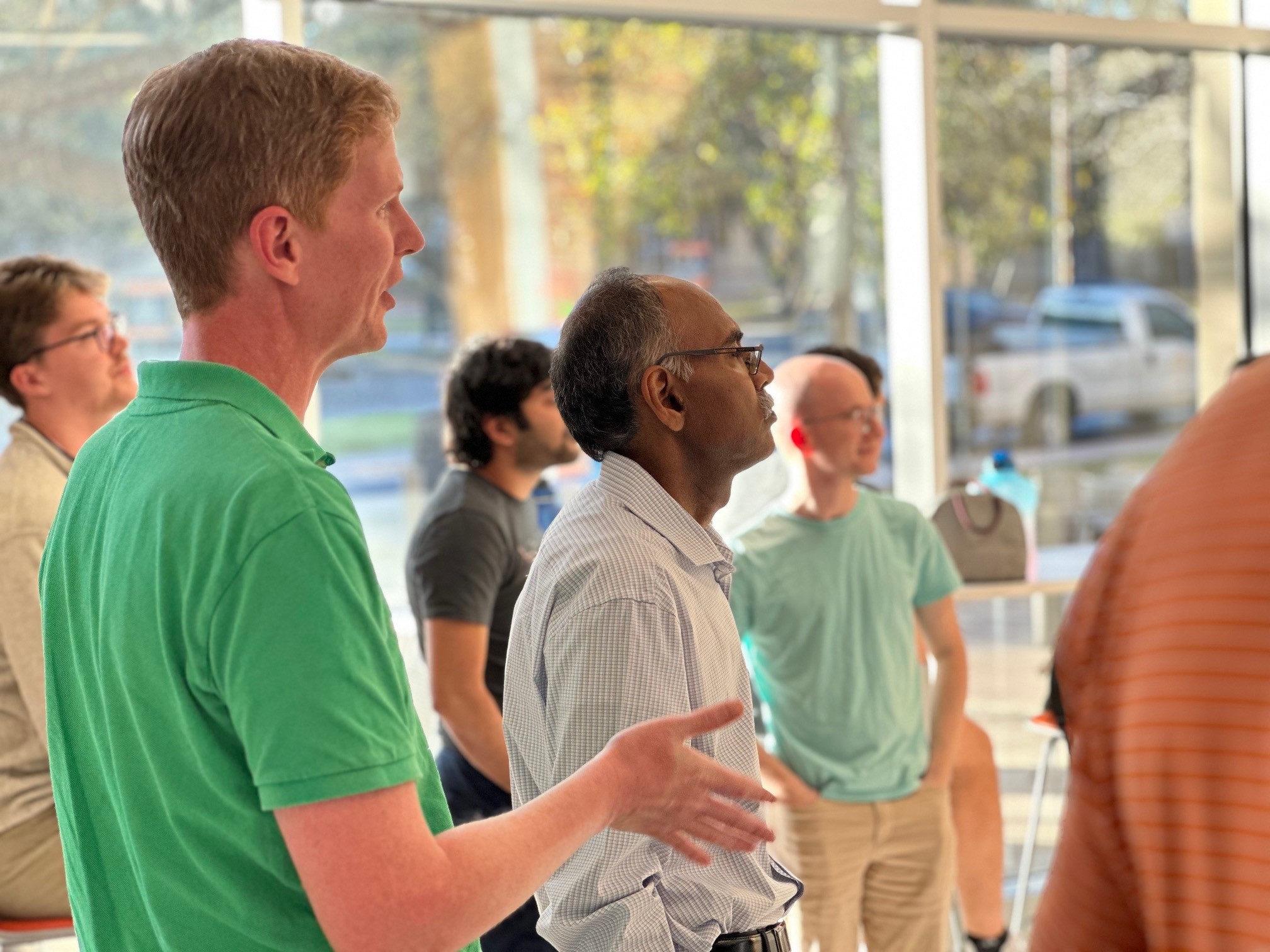 Maruthi Akella and Brandon Jones standing in crowd of Texas engineers