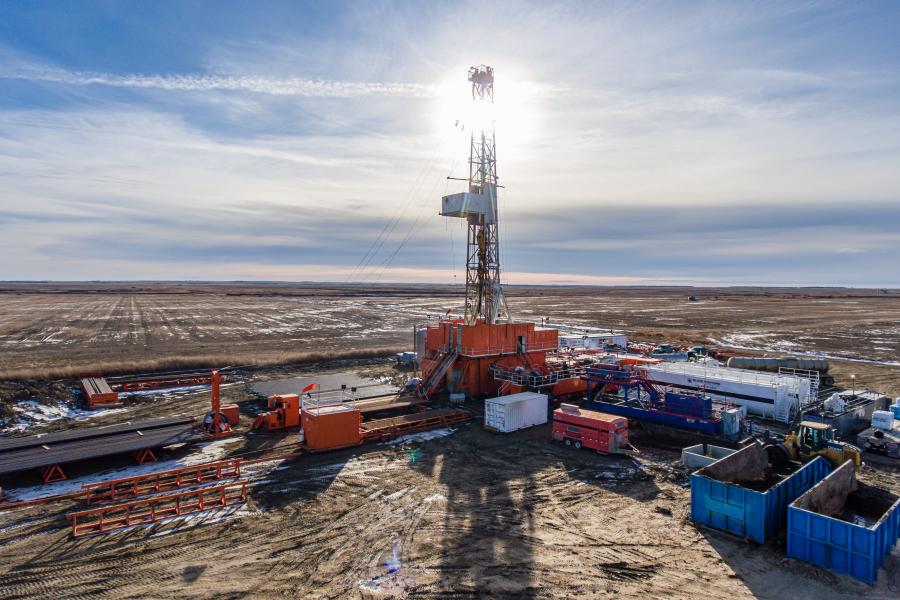 geothermal energy production facility in the desert with various equipment and vehicles