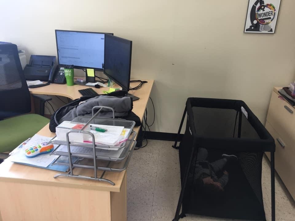 Kasey Faust's child naps in her office while she participates in a virtual conference.