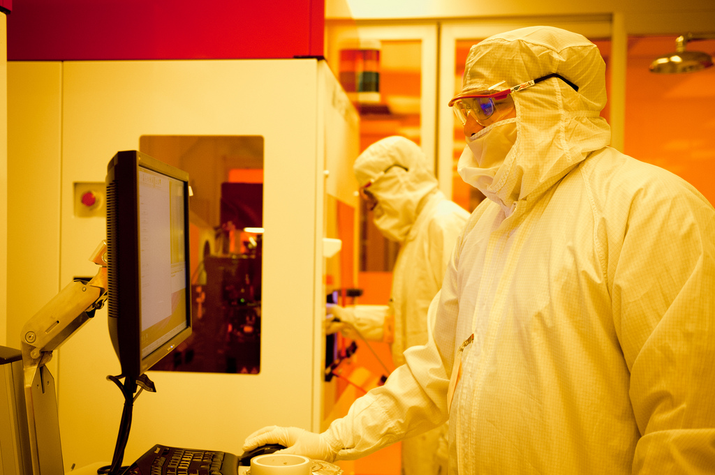 Two Cockrell School of Engineering researchers looking at computers in the Nascent Lab