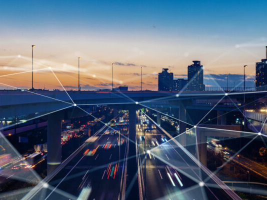 blurred photo of traffic and city lights at sunset