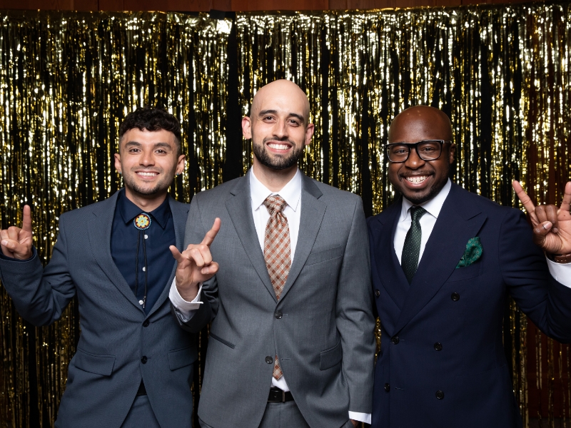Texas engineering students smiling in front of gold backdrop