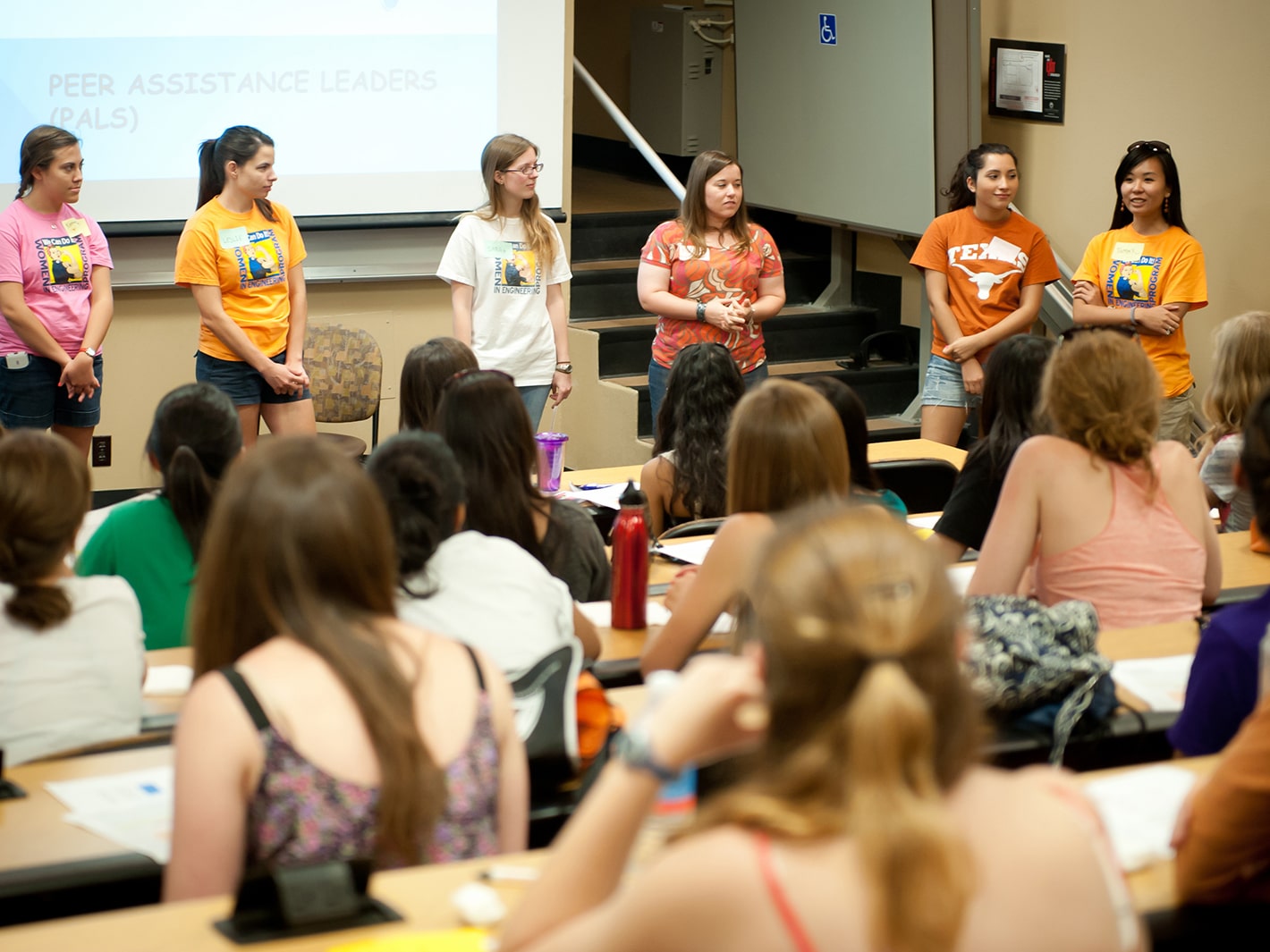 A class of Texas engineering students listening to female students speak