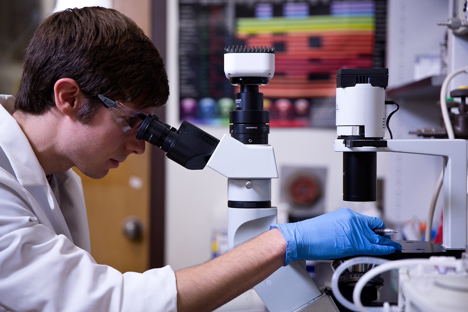 student looking through a microscope